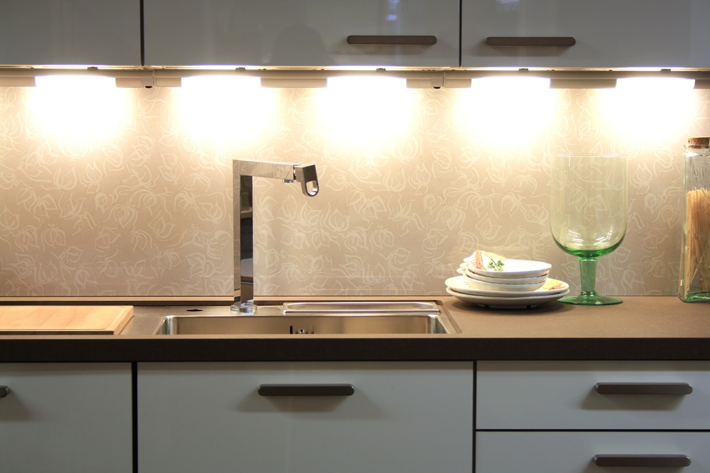 Layered lighting above a kitchen worktop