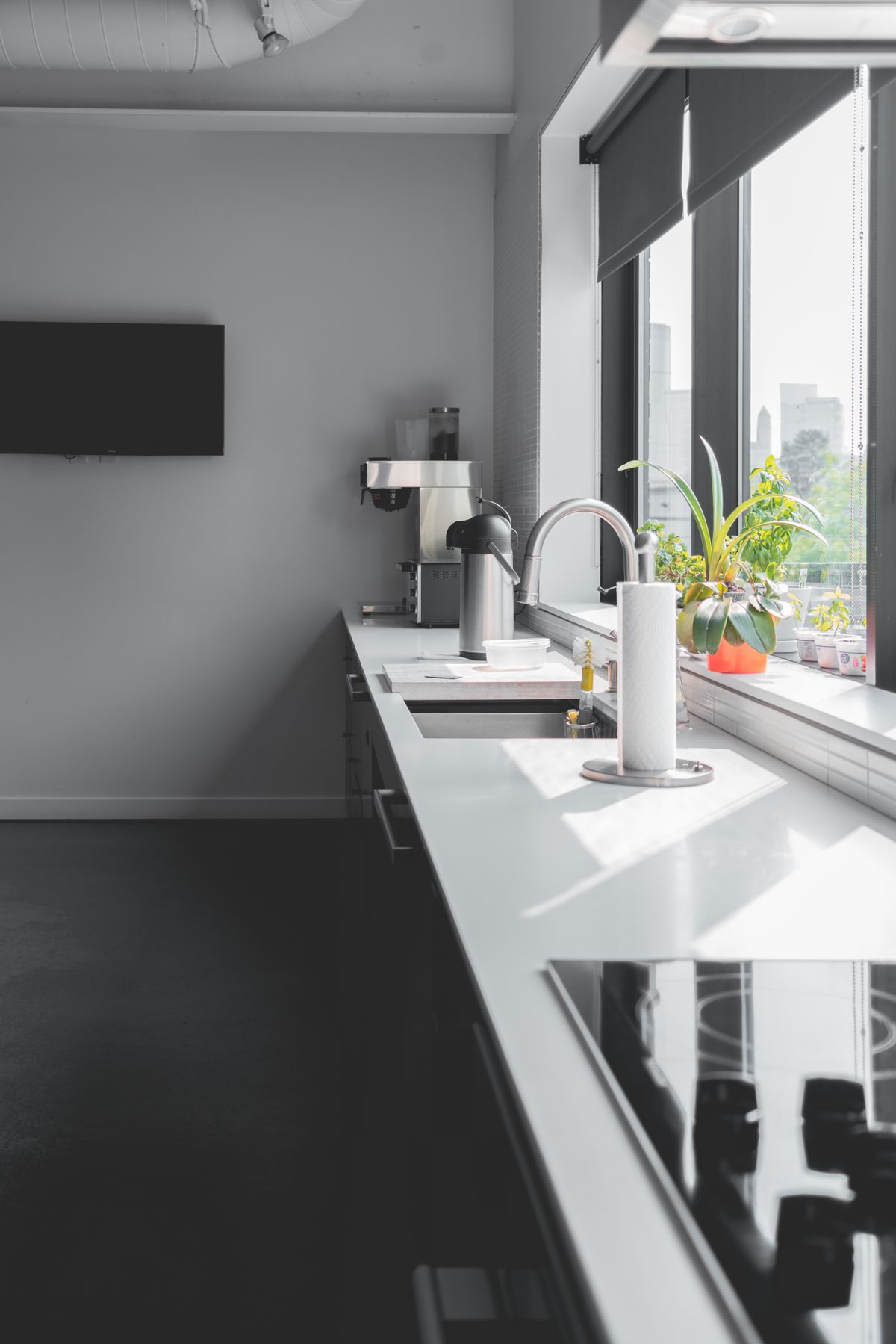 Bright worktop beside a window with potted herbs