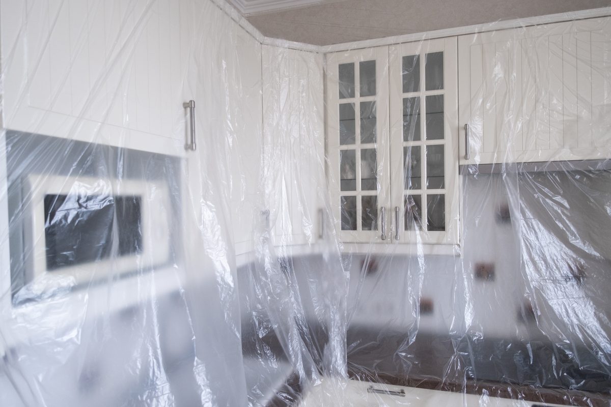 A kitchen under renovation covered against weather