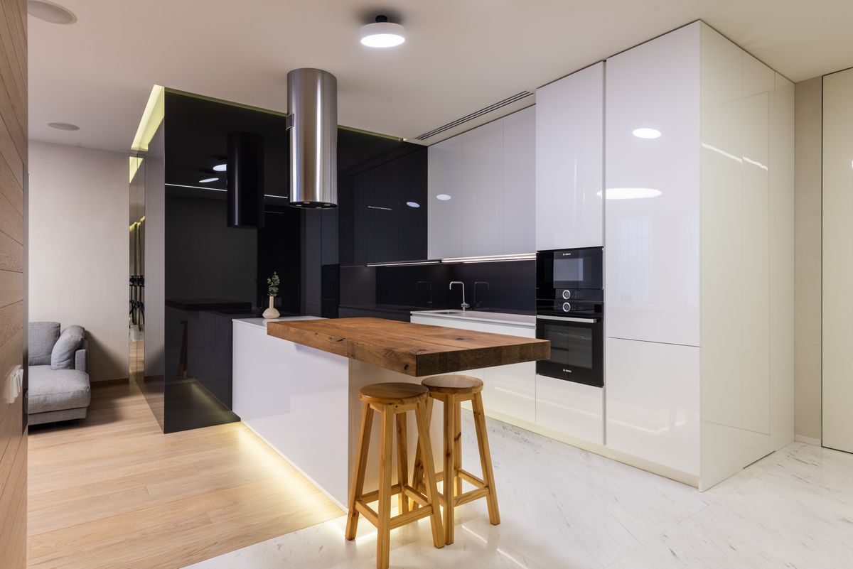 White gloss kitchen with a reclaimed timber breakfast bar