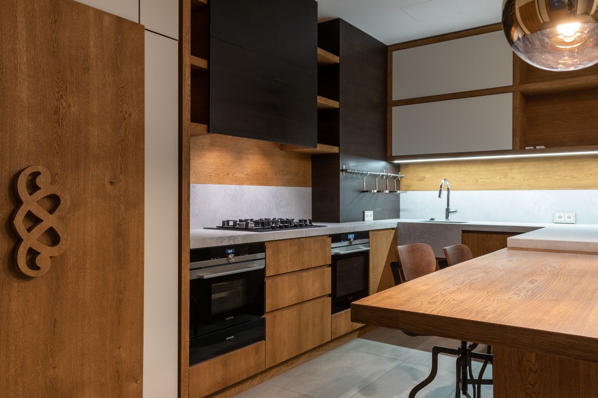 Open plan oak kitchen with island seating and pendant lighting