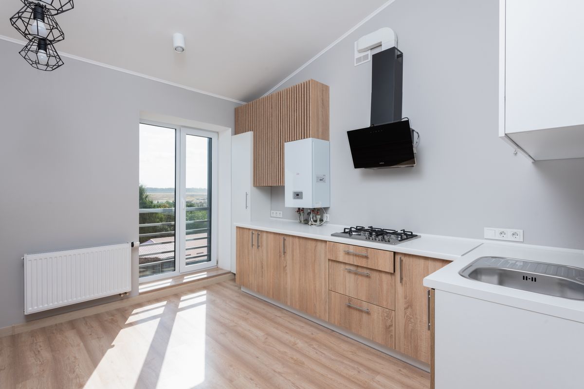 Small light oak kitchen with a balcony window