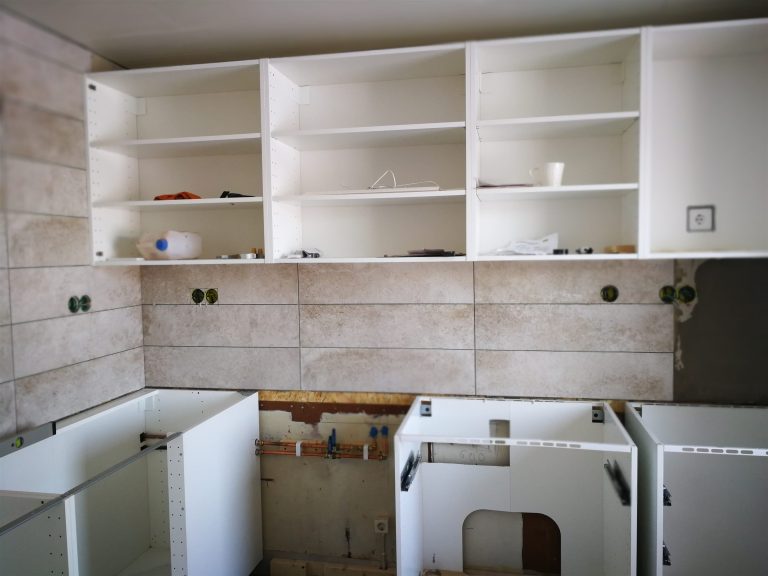 White kitchen cabinet boxes installed before the countertop and doors go on